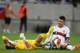 Newcastle United goalkeeper Martin Dubravka is caught by Cristiano Ronaldo (Photo by VLADIMIR SIMICEK/AFP via Getty Images)
