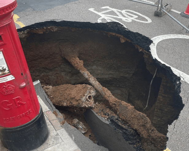 Mysterious sinkhole appears in UK and almost gobbles post box - motorists beware 