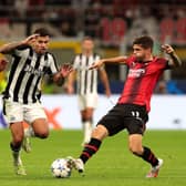 Bruno Guimaraes of Newcastle United challenges for the ball with Olivier Giroud and Christian Pulisic of AC Milan during the UEFA Champions League Group F match between AC Milan and Newcastle United FC at Stadio Giuseppe Meazza on September 19, 2023 in Milan, Italy. 