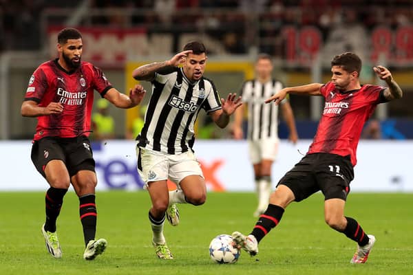 Bruno Guimaraes of Newcastle United challenges for the ball with Olivier Giroud and Christian Pulisic of AC Milan during the UEFA Champions League Group F match between AC Milan and Newcastle United FC at Stadio Giuseppe Meazza on September 19, 2023 in Milan, Italy. 