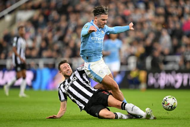 Paul Dummett crunches into yet another tackle against Jack Grealish. 