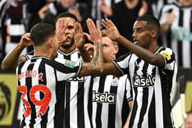 Newcastle United’s Swedish striker #14 Alexander Isak (R) celebrates scoring the opening goal during the English League Cup third round football match between Newcastle United and Manchester City at St James' Park in Newcastle-upon-Tyne, north east England on September 27, 2023. (Photo by Oli SCARFF / AFP) 