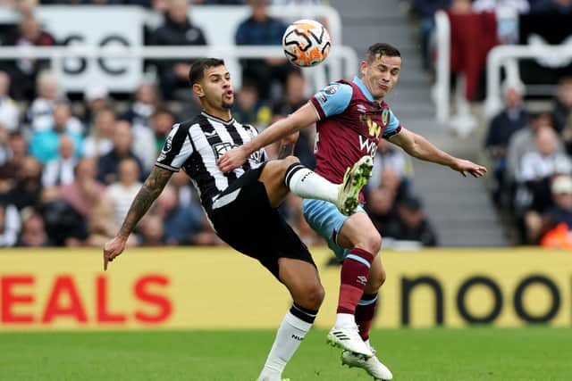 Bruno Guimaraes of Newcastle United and Josh Cullen of Burnley battle for the ball during the Premier League match between Newcastle United and Burnley FC at St. James Park on September 30, 2023 in Newcastle upon Tyne, England. 