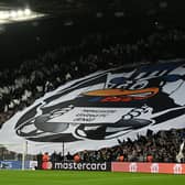 Newcastle fans hold flags and banners ahead of the UEFA Champions League Group F football match between Newcastle United and Paris Saint-Germain at St James’ Park in Newcastle-upon-Tyne, north east England on October 4, 2023. (Photo by Paul ELLIS / AFP) /