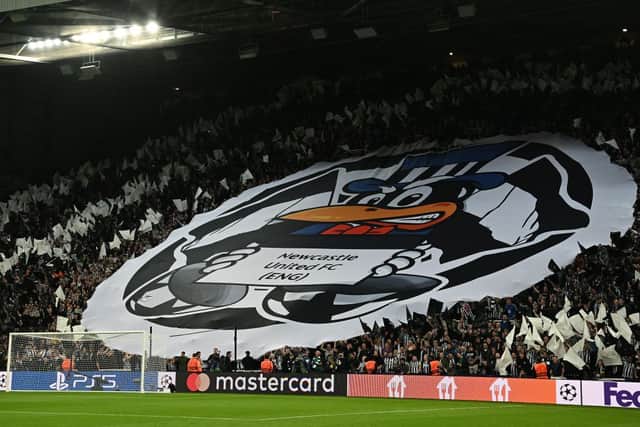 Newcastle fans hold flags and banners ahead of the UEFA Champions League Group F football match between Newcastle United and Paris Saint-Germain at St James’ Park in Newcastle-upon-Tyne, north east England on October 4, 2023. (Photo by Paul ELLIS / AFP) /