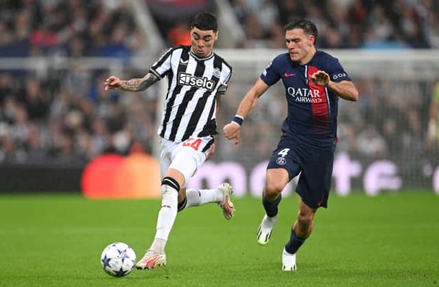 Newcastle player Miguel Almiron races past PSG defender Manuel Ugarte during the UEFA Champions League match between Newcastle United FC and Paris Saint-Germain at St. James Park on October 04, 2023 in Newcastle upon Tyne, England. (Photo by Stu Forster/Getty Images)