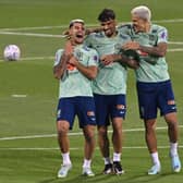 Brazil's midfielders Bruno Guimaraes (L) and Lucas Paqueta and forward Pedro laugh during a training session at the Al Arabi SC Stadium in Doha on November 20, 2022, just moments before the kick-off of the Qatar 2022 World Cup football tournament. (Photo by NELSON ALMEIDA / AFP)