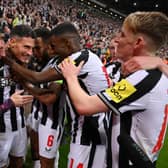 Fabian Schar of Newcastle United celebrates with teammates after scoring the team's fourth goal during the UEFA Champions League match between Newcastle United FC and Paris Saint-Germain at St. James Park on October 04, 2023 in Newcastle upon Tyne, England. (Photo by Stu Forster/Getty Images)