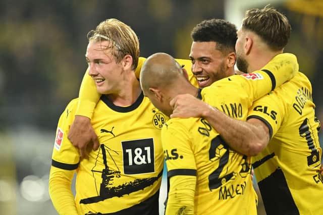 ulian Brandt (L) celebrates scoring the opening goal with his teammates during the German first division Bundesliga football match between BVB Borussia Dortmund and SV Werder Bremen in Dortmund, western Germany on October 20, 2023. (Photo by INA FASSBENDER / AFP) 