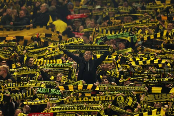 Borussia Dortmund fans show their support whilst holding up scarves prior to the Bundesliga match between Borussia Dortmund and SV Werder Bremen at Signal Iduna Park on October 20, 2023 in Dortmund, Germany. 