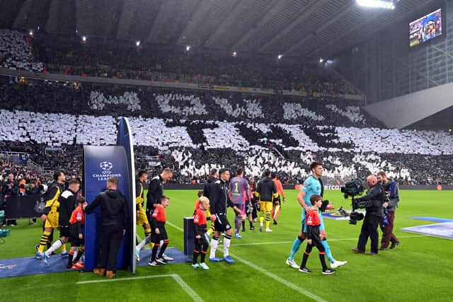 The two sides enter the field as the Newcastle fans display a Howay The Lads message prior to the UEFA Champions League match between Newcastle United FC and Borussia Dortmund at St. James Park on October 25, 2023 in Newcastle upon Tyne, England. (Photo by Stu Forster/Getty Images)