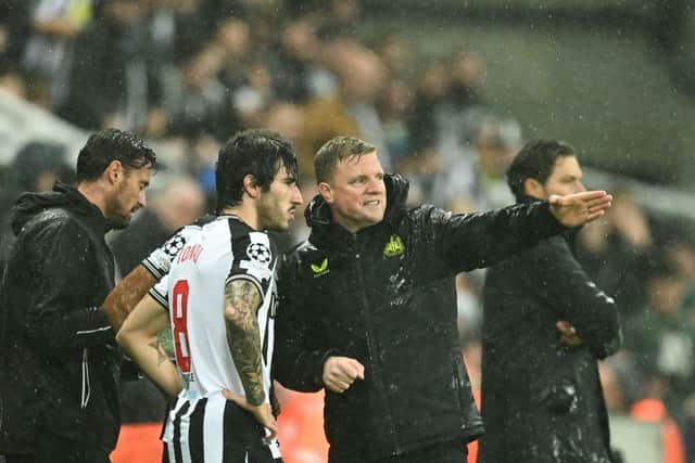 Newcastle United's Italian midfielder #08 Sandro Tonali (L) speaks with Newcastle United's English head coach Eddie Howe prior to enter the pitch during the UEFA Champions League Group F football match between Newcastle United and Borussia Dortmund at St James' Park in Newcastle-upon-Tyne, north east England, on October 25, 2023. (Photo by Oli SCARFF / AFP)