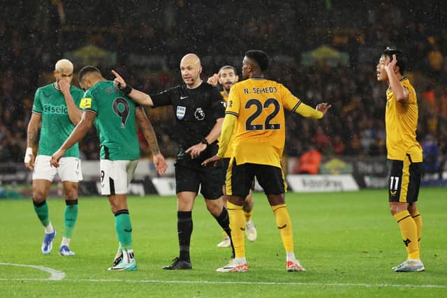 Referee Anthony Taylor awards Newcastle United a penalty kick during the Premier League match between Wolverhampton Wanderers and Newcastle United at Molineux on October 28, 2023 in Wolverhampton, England. (Photo by Matt McNulty/Getty Images)