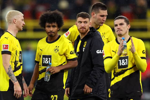 Marco Reus, Karim Adeyemi, Salih Ozcan and Marcel Sabitzer of Borussia Dortmund look dejected at full-time after their team's defeat in the Bundesliga match between Borussia Dortmund and FC Bayern MÃ¼nchen at Signal Iduna Park on November 04, 2023 in Dortmund, Germany. (Photo by Lars Baron/Getty Images)