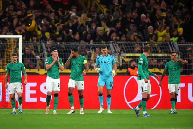 Players of Newcastle United look dejected after conceding a goal during the UEFA Champions League match between Borussia Dortmund and Newcastle United.