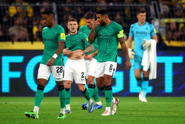 Kieran Trippier (C) and Jamaal Lascelles of Newcastle United react as they leave the pitch for half-time during the UEFA Champions League match between Borussia Dortmund and Newcastle United at Signal Iduna Park on November 07, 2023 in Dortmund, Germany. (Photo by Alex Grimm/Getty Images)