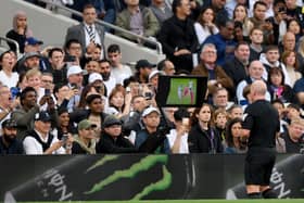 Referee, Simon Hooper watches the Video Assistant Referee before awarding a red card to Curtis Jones of Liverpool during the Premier League match between Tottenham Hotspur and Liverpool. (Photo by Justin Setterfield/Getty Images)