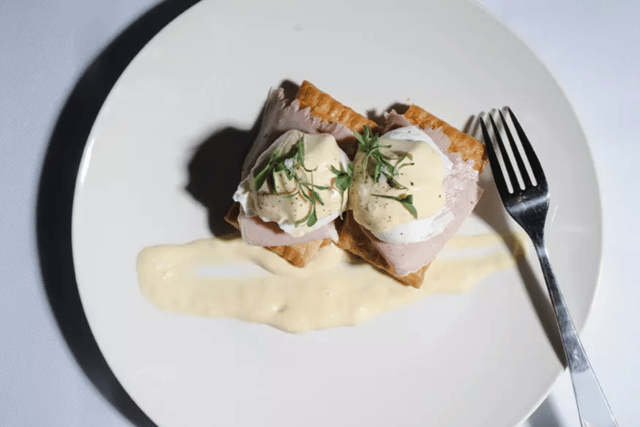 A "Greggs Benedict" which combines a Sausage, Bean and Chesse Melt with smoked ham, poached Cacklebean eggs and Hollandaise sauce. Photo: Fenwick.