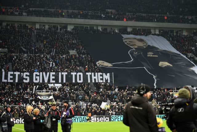 Newcastle fans unfurl a large banner on Newcastle United's English head coach Eddie Howe ahead of the English Premier League football match between Newcastle United and Manchester United at St James' Park in Newcastle-upon-Tyne, north east England on December 2, 2023. (Photo by ANDY BUCHANAN / AFP) 