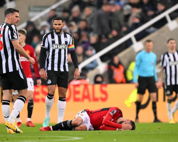  Bruno Fernandes of Manchester United goes down with an injury after being tackled by Fabian Schaer during the Premier League match between Newcastle United and Manchester United. (Photo by Stu Forster/Getty Images)