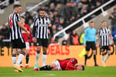  Bruno Fernandes of Manchester United goes down with an injury after being tackled by Fabian Schaer during the Premier League match between Newcastle United and Manchester United. (Photo by Stu Forster/Getty Images)