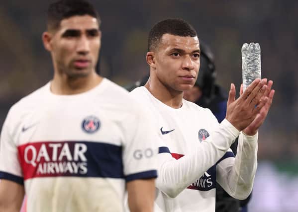 Paris Saint-Germain's French forward #07 Kylian Mbappe (R) reacts at the end of the UEFA Champions League group F football match with Borussia Dortmund. (Photo by FRANCK FIFE/AFP via Getty Images)