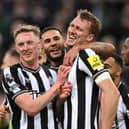 Dan Burn of Newcastle United (R) celebrates with teammates Emil Krafth and Callum Wilson after scoring their team's third goal during the Premier League match between Newcastle United and Fulham FC at St. James Park on December 16, 2023 in Newcastle upon Tyne, England.