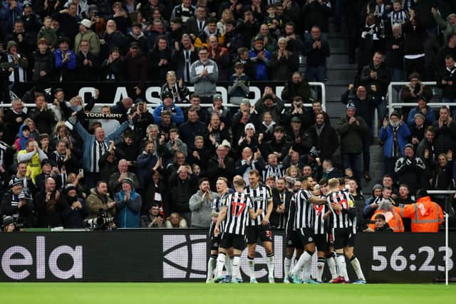Lewis Miley of Newcastle United (obscured) celebrates with teammates after scoring their team's first goal during the Premier League match between Newcastle United and Fulham FC. (Photo by Clive Brunskill/Getty Images)