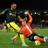 Callum Wilson of Newcastle United and Mads Juel Andersen of Luton Town battle for possession during the Premier League match between Luton Town and Newcastle United at Kenilworth Road on December 23, 2023 in Luton, England. 