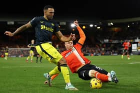 Callum Wilson of Newcastle United and Mads Juel Andersen of Luton Town battle for possession during the Premier League match between Luton Town and Newcastle United at Kenilworth Road on December 23, 2023 in Luton, England. 