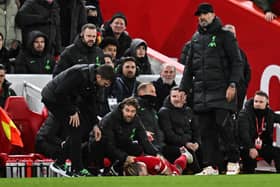 Liverpool manager Jurgen Klopp (R) stands next to Liverpool defender #21 Kostas Tsimikas (C) injured following a collision reacting as he lays on the pitch.  (Photo by PAUL ELLIS/AFP via Getty Images)