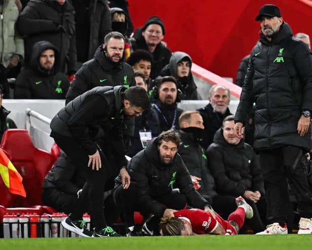 Liverpool manager Jurgen Klopp (R) stands next to Liverpool defender #21 Kostas Tsimikas (C) injured following a collision reacting as he lays on the pitch.  (Photo by PAUL ELLIS/AFP via Getty Images)