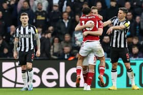 Chris Wood of Nottingham Forest celebrates with team mate Morgan Gibbs-White after scoring their sides third goal during the Premier League match between Newcastle United and Nottingham Forest at St. James Park on December 26, 2023 in Newcastle upon Tyne, England. 