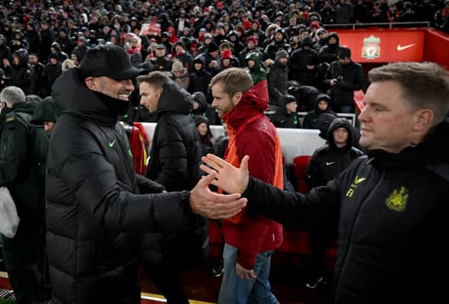 Jurgen Klopp manager of Liverpool with Eddie Howe manager of Newcastle United at the start of the Premier League match between Liverpool FC and Newcastle United at Anfield on January 01, 2024 in Liverpool, England. 