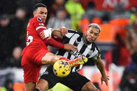 Liverpool defender Trent Alexander-Arnold vies with Newcastle United's Joelinton.  (Photo by PETER POWELL/AFP via Getty Images)