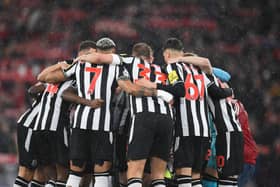 Newcastle players form a group huddle ahead of kick-off in the English Premier League football match between Liverpool and Newcastle United at Anfield in Liverpool, north west England on January 1, 2024. (Photo by PETER POWELL / AFP)