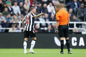 Kieran Trippier of Newcastle United interacts with Match Referee Craig Pawson during the Premier League match between Newcastle United and Brentford FC. (Photo by George Wood/Getty Images)