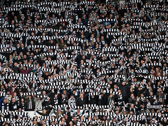Newcastle fans hold scarves in the air during the Emirates FA Cup Third Round match against Sunderland (Photo by Michael Regan/Getty Images)