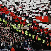 Newcastle fans and Sunderland fans are separated by a line of police officers ahead of the English FA Cup third round tie.