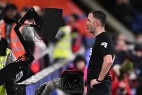 Chris Kavanagh checks VAR ahead of showing a red card to Everton striker Dominic Calvert-Lewin. (Photo by Mike Hewitt/Getty Images)