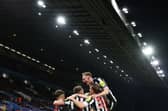 Newcastle United's Swiss defender #05 Fabian Schar celebrates with teammates after scoring his team second goal during the English Premier League football match between Aston Villa and Newcastle United at Villa Park in Birmingham, central England on January 30, 2024. (Photo by Adrian DENNIS / AFP) / 