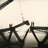 The Tyne Bridge arch is nearly complete as a girder is lowered into place above the River Tyne, 23 February 1928 