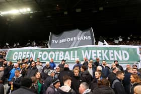 Fans of Newcastle United hold up banners reading 'Tv Before Fans' and 'Green Football Weekend' during the Premier League match between Newcastle United and Luton Town at St. James Park. (Photo by Matt McNulty/Getty Images)