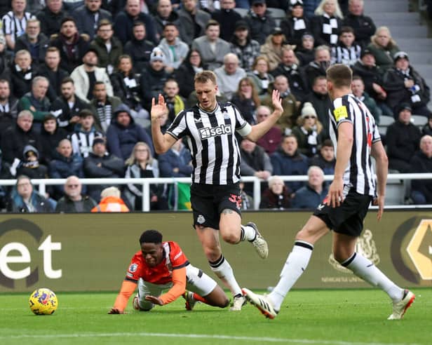 Newcastle United defender Dan Burn concedes a penalty against Luton Town. (Photo by George Wood/Getty Images)