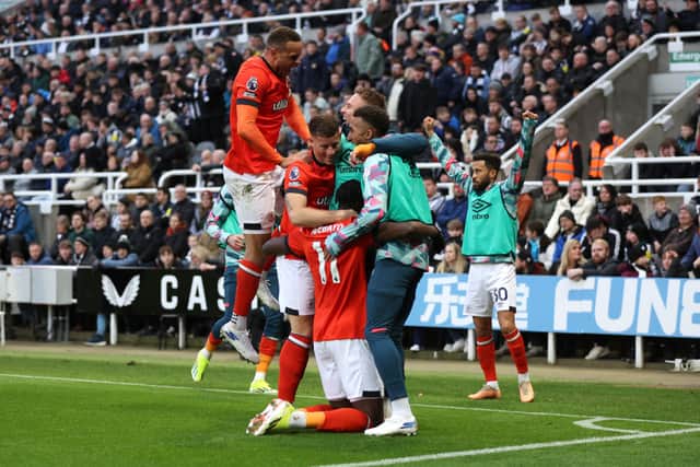 Elijah Adebayo celebrates scoring Luton Town's fourth goal against Newcastle United with Carlton Morris, Ross Barkley and teammates.(Photo by George Wood/Getty Images)
