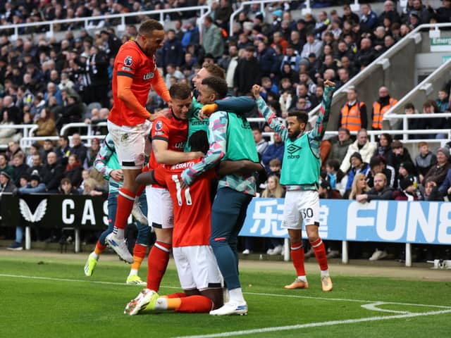 Elijah Adebayo celebrates scoring Luton Town's fourth goal against Newcastle United with Carlton Morris, Ross Barkley and teammates.(Photo by George Wood/Getty Images)