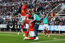 Elijah Adebayo celebrates scoring Luton Town's fourth goal against Newcastle United with Carlton Morris, Ross Barkley and teammates.(Photo by George Wood/Getty Images)