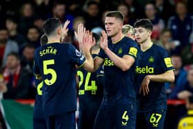 Fabian Schar of Newcastle United celebrates scoring his team's second goal with teammate Sven Botman during the Premier League match between Nottingham Forest and Newcastle United at City Ground on February 10, 2024 in Nottingham, England.
