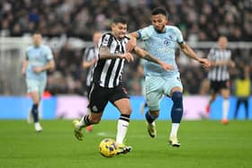 Bruno Guimaraes of Newcastle United is challenged by Lloyd Kelly of AFC Bournemouth during the Premier League match between Newcastle United and AFC Bournemouth at St. James Park on February 17, 2024 in Newcastle upon Tyne, England.