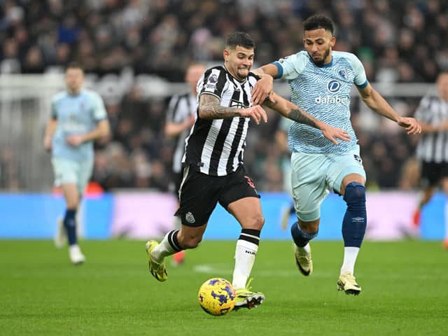 Bruno Guimaraes of Newcastle United is challenged by Lloyd Kelly of AFC Bournemouth during the Premier League match between Newcastle United and AFC Bournemouth at St. James Park on February 17, 2024 in Newcastle upon Tyne, England.